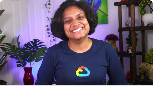 Woman smiling at camera wearing a Google Cloud long-sleeve t-shirt.