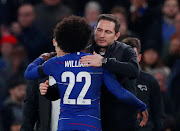 Derby County manager Frank Lampard hugs Chelsea's Willian after a League Cup fourth round match at Stamford Bridge in London on October 31, 2018.