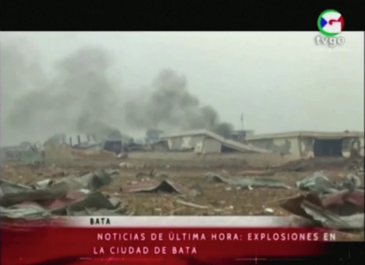 Smoke rises from destroyed structures following explosions at a military base, according to local media, in Bata, Equatorial Guinea on March 7, 2021.