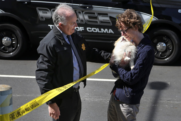 Burlingame police chief Eric Wollman hands off Kimba to his owner following an active shooter situation at Youtube headquarters in San Bruno, California, US, on April 3, 2018. According to his owner, Kimba was present when the shooting occurred.