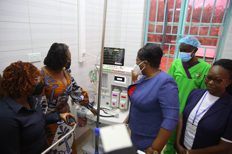 Governor Wanga inspects a machine at the new maternity facility.