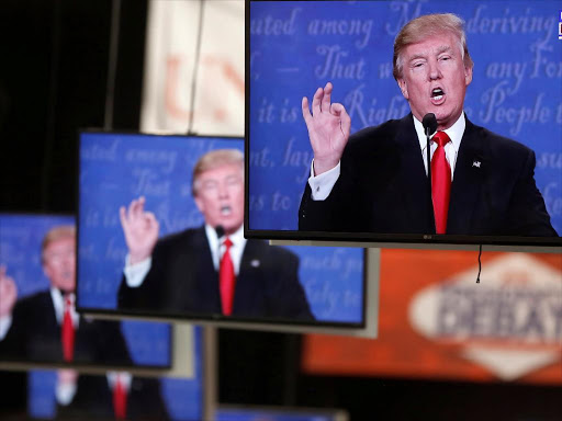 Republican US presidential nominee Donald Trump is shown on TV monitors in the media filing room on the campus of University of Nevada, Las Vegas, during the last 2016 US presidential debate in Las Vegas, US, October 19, 2016. /REUTERS