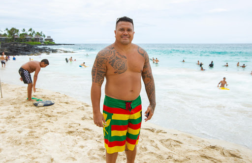 Keo-Ho-at-magic-sands-.jpg - Keo Ho shows off tattoos that tell the story of his Polynesian heritage, at Magic Sands beach.