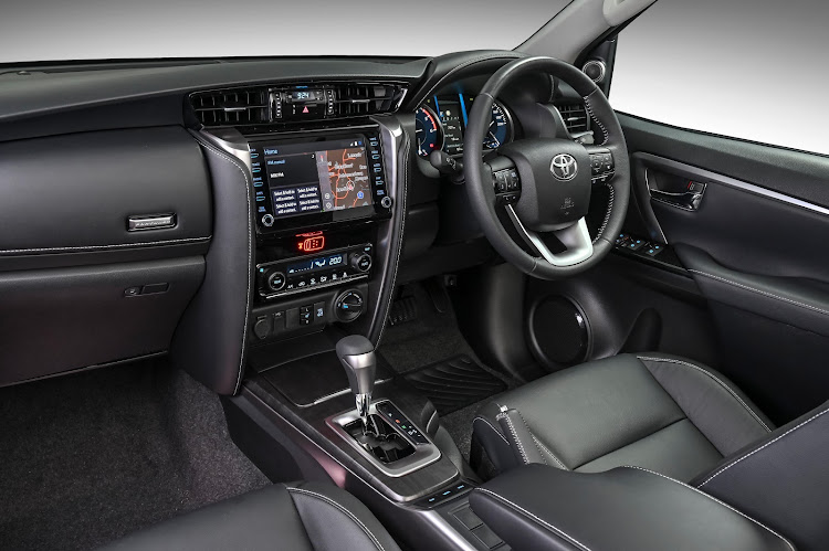 A big change inside the Fortuner cabin is a digitised central display while a long-standing feature is the pair of side-folding seats. Picture: SUPPLIED