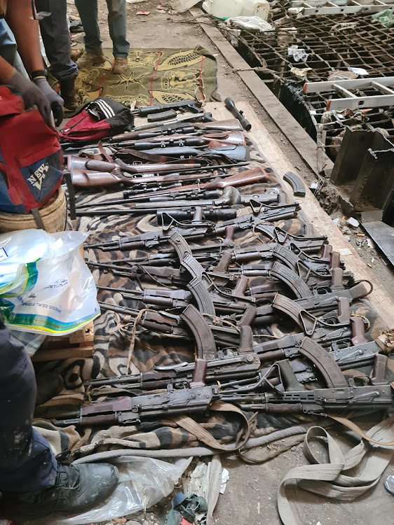 Some of the firearms seized by the Hawks during a raid at a mine shaft in Stilfontein, North West, on Monday morning. Twenty suspects were arrested.