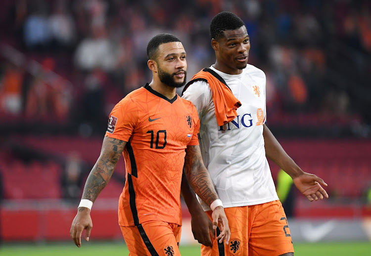 Netherlands' Memphis Depay and Denzel Dumfries after a past match