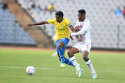 Mamelodi Sundowns' Teboho Mokoena is challenged by Evans Rusike of Swallows FC in the DStv Premiership match at Dobsonville Stadium on April 9 2023.