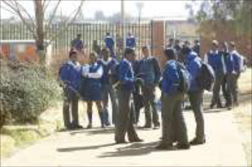 BREAK TIME: Pupils of Badirile High School in Khutsong during a break. Most of the matric pupils in this volatile area have left to prepare for exams. Pic. Peter Mogaki. 17/07/07. © Sowetan.