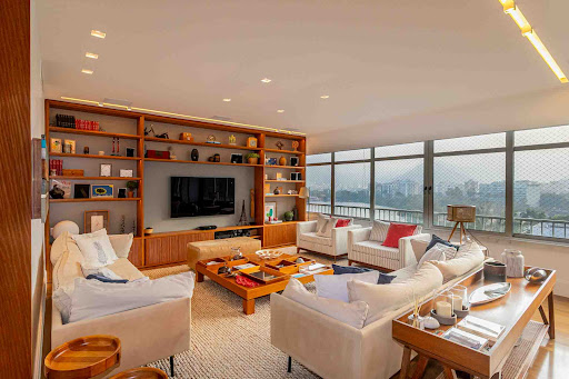Modern living room with wall shelves and panoramic view - Buy this luxury property in Rio de Janeiro, 4 bedrooms