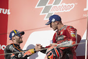 Jack Miller (right) celebrates his Japanese MotoGP victory with Brad Binder (left) on the podium. 