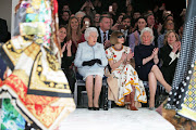  Queen Elizabeth II sits with Anna Wintour as they view Richard Quinn's runway show during London Fashion Week on February 20 2018.