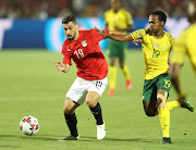 Bafana Bafana star forward Percy Tau (R) vies for the ball against Abdallah El Said of Egypt during a last-16 clash which South Africa won 1-0 to knock out the host nation out of the Africa Cup of Nations.   