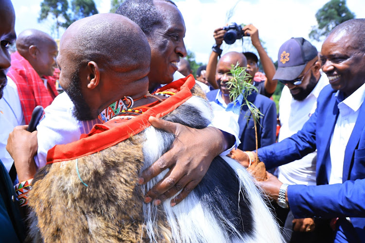 Media Personality Stephen hugs Narok Governor Patrick Ole Ntutu during his Thanksgiving ceremony at Enooretet Village in Narok County on October 13, 2023.