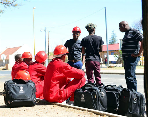 Members of the Economic Freedom Fighters sitting on the pavement waiting for transport after they were denied access to enter the Mahikeng Local Municipality Chamber due to their dress code. Photo: Tiro Ramatlhatse