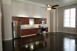 Fully equipped kitchen with dark wood shaker cabinets and granite countertops