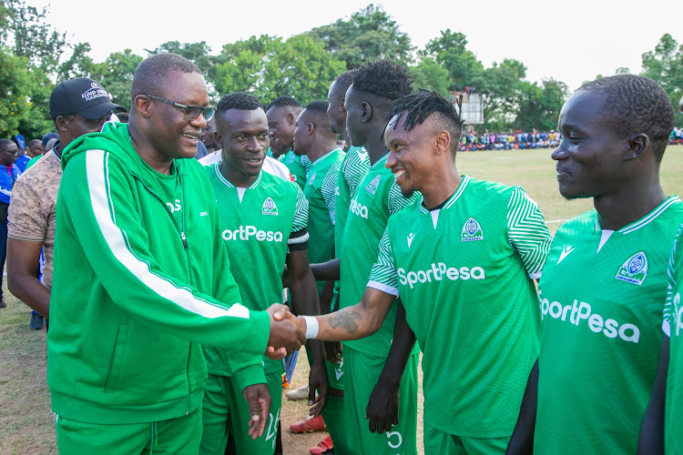 ICT and Digital Economy Cabinet Secretary Eliud Owalo with Gor Mahia players during a friendly match with Nyanza Combined at Nyilima grounds in Siaya county on Saturday.