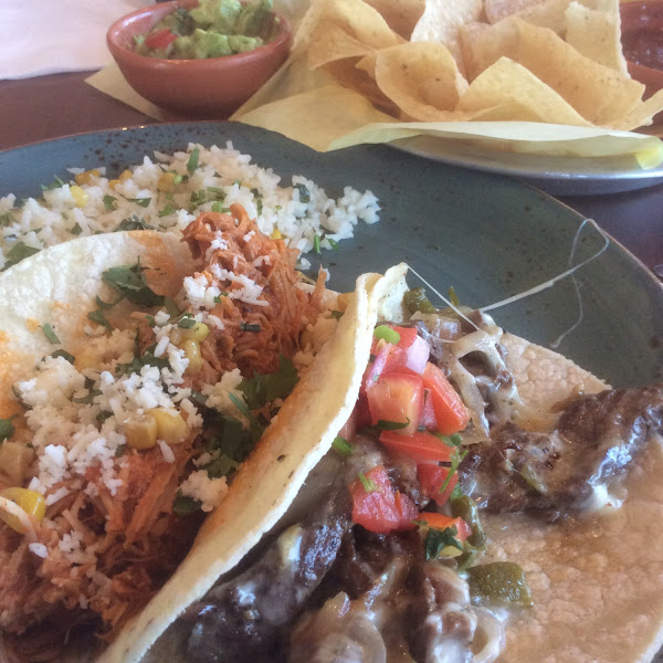 Shredded chicken and beef fajita tacos on corn tortillas with cilantro lime rice