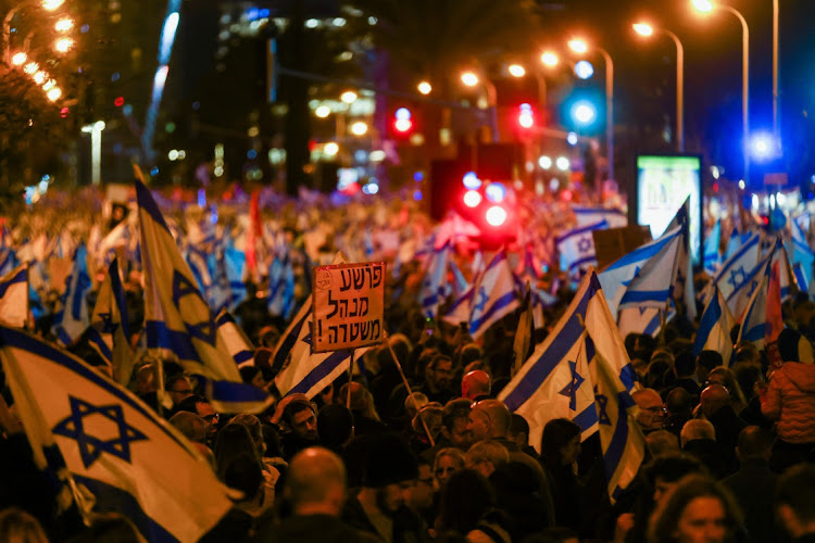 Israelis hold flags as they protest against Prime Minister Benjamin Netanyahu's proposed judicial reforms to reduce powers of the supreme court in Tel Aviv, Israel, February 4 2023. Picture: RONEN ZVULUN/REUTERS