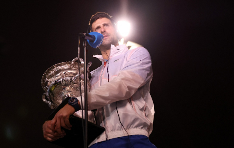 Serbia's Novak Djokovic is pictured with the trophy during an interview after winning his final match against Greece's Stefanos Tsitsipas at the 2023 Australian Open at Melbourne Park on January 29 2023.