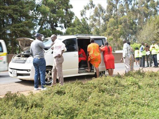 Some of the passengers stranded after their cars were impounded for engaging in illegal PSV business. Number plates were removed before they were toed to Tigoni police. /PATRICK VIDIJA