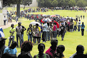 A few of the thousands of matrics who have applied to study at the Tshwane University of Technology queue on a campus sports field hoping against hope that they will be allowed to enrol