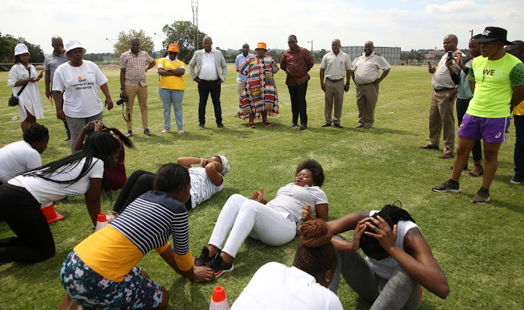 The community safety MEC Faith Mazibuko and premier Panyaza Lesufi watch potential recruits go through their paces at Modderbee Correctional Services.