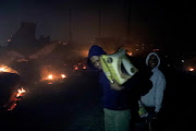 Children flee as a blaze engulfs the Dakota informal settlement  in Isipingo.