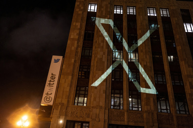 Twitter's new logo is seen projected on the corporate headquarters building in downtown San Francisco, California.