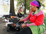 HEAD START  Mampine Leoka, right, and Puleng Matsipe sell 'skopo' at night on the side of the road in Soweto as a means of survival.