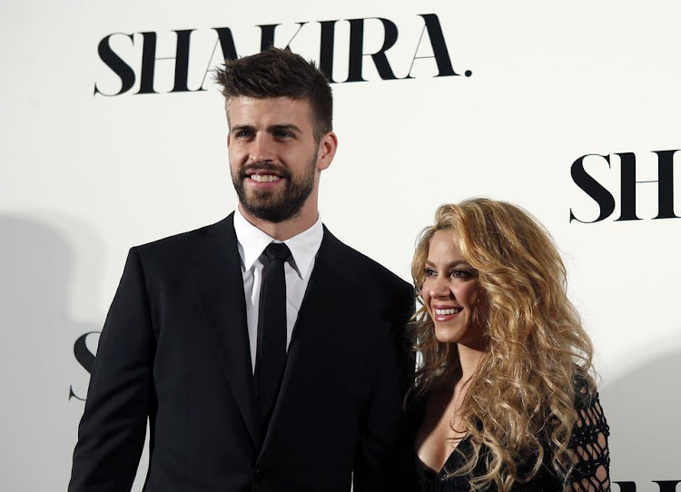 Colombian singer Shakira and FC Barcelona's soccer player Gerard Pique (L) pose during a photocall presenting her new album "Shakira" in Barcelona March 20, 2014.