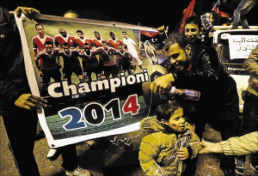 BASKING IN AFTERGLOW: Libyans celebrate in Tripoli on Saturday after their team won the African Nations Championship final match against Ghana in Cape Town PHOTO: Mahmud TURKIA/AFP