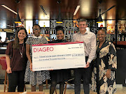 Diageo SA's finance director Natalie Zaroudoukas, left, presents the cheque to  Tshwaranang.