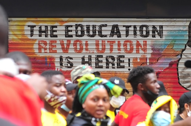 Wits University students sing and chant struggle songs during a protest in Johannesburg near where a man was shot dead with rubber bullets after coming out of a clinic.