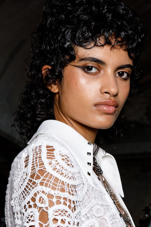 A model shows off her bouncy curls backstage at the John Richmond fashion show.