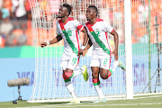 Bertrand Traore of Burkina Faso celebrates his late penalty with a teammate that helped his team to a 1-0 win over Mauritania during their Africa Cup of Nations (Afcon) group stage match at Peace Stadium in Bouake.