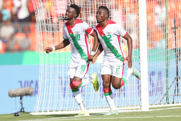 Bertrand Traore of Burkina Faso celebrates his late penalty with a teammate that helped his team to a 1-0 win over Mauritania during their Africa Cup of Nations (Afcon) group stage match at Peace Stadium in Bouake.