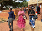 Businesswoman and beauty pageant title holder Basetsana Kumalo leaves the Randburg magistrate's court with  friends.