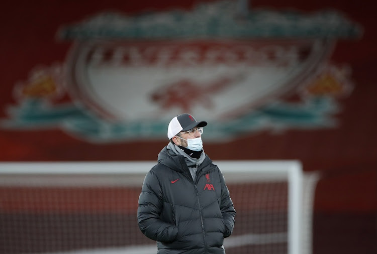 Jurgen Klopp, Manager of Liverpool wears a face mask as he looks on during the warm ups prior to the Premier League match between Liverpool and Tottenham Hotspur at Anfield on December 16, 2020 in Liverpool, England.