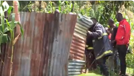 Residents and police gathered around the pit latrine where a baby fell in after he or she was born in Kakamega county on July 30, 2023.