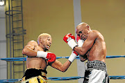 Azinga Fuzile, left, hits out at  Malcolm Klassen during a bout that was named 2018 Africa's fight of the year by IBF.  Fuzile is being prepared for a world title fight. 