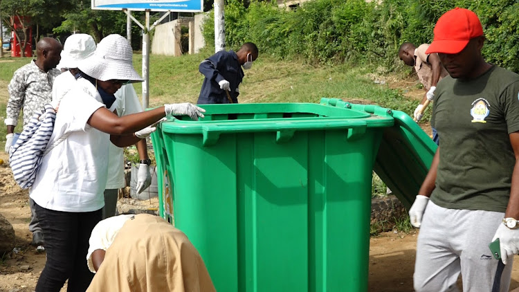 Progress Welfare Association of Malindi officials with Malindi Muncipality officials install a bin at BP area