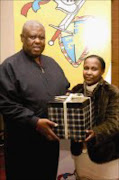 THANKS: Molefi Oliphant receives a special gift from hope Hlongwane, the principal of Thabo Vuyo School for the mentally challenged. 20/08/07. © Unknown.