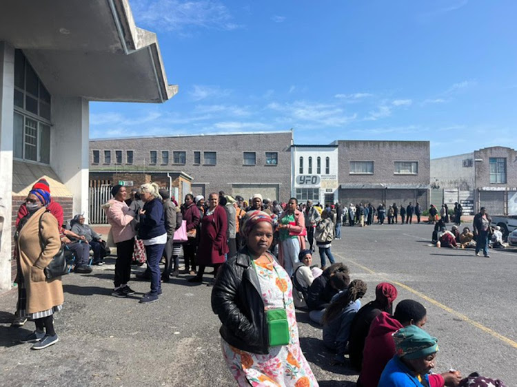 Social grant beneficiaries stand in a snaking line outside the post office in Gatesville. Picture: Ella Morrison