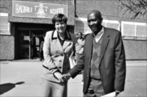 SHAKE ON IT: Jomo Mogale and education MEC Barbara Creecy outside the Badirile High School in Khutsong ye st e r d a y. Mogale was reinstated after his dismissal for taking an active part in the Khutsong protests last ye a r. Pic: VATHISWA RUSELO. 12/08/2009. © Sowetan