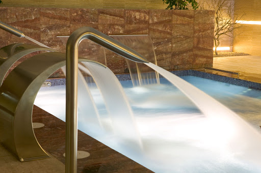 una fuente de agua en una piscina con escaleras que conducen a ella
