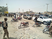 Security officers gather at the site of a blast outside a polling station in Quetta, Pakistan, July 25, 2018. 