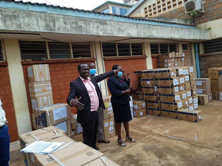 Embu Health executive John Mukundi and other health officials while receiving drugs from Kemsa at Embu Level 5 hospital on Wednesday, March 23.