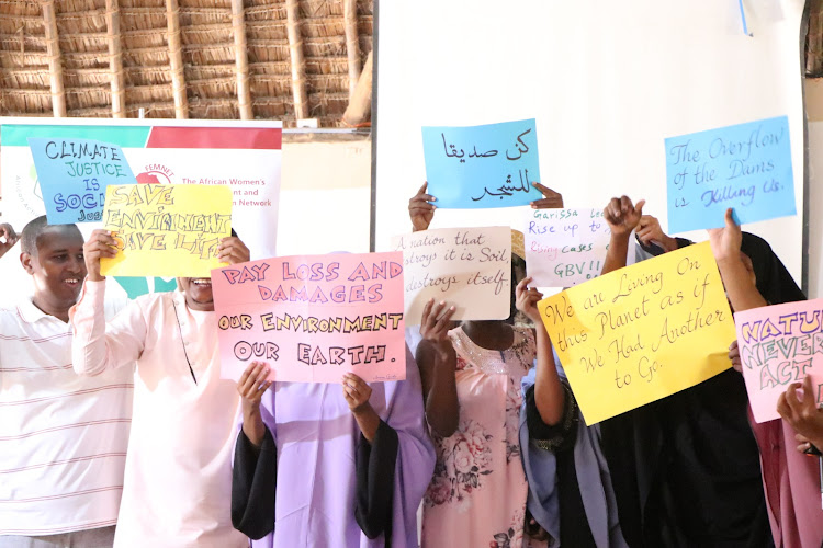 Activists from Garissa display banners with messages on the need to protect the environment