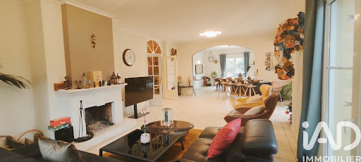 Living room with fireplace and open dining room - Buy this luxury house in Gex, 8 rooms, 5 bedrooms