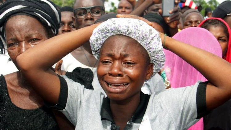 Women mourning after worshippers died in an attack on a church in 2018